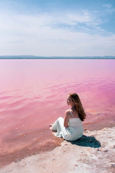 cute-teenager-woman-wearing-white-dress-sitting-amazing-pink-lake